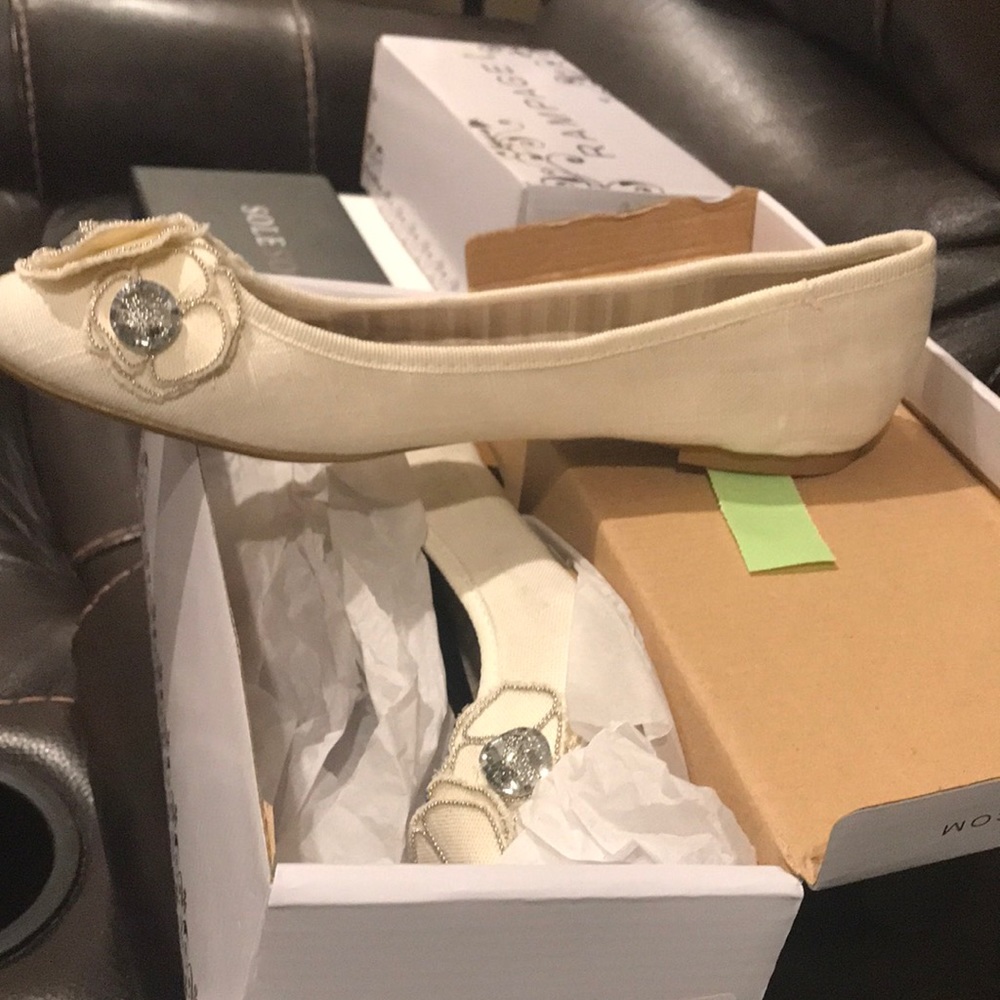 Cream colored fabric ballerina style slip on